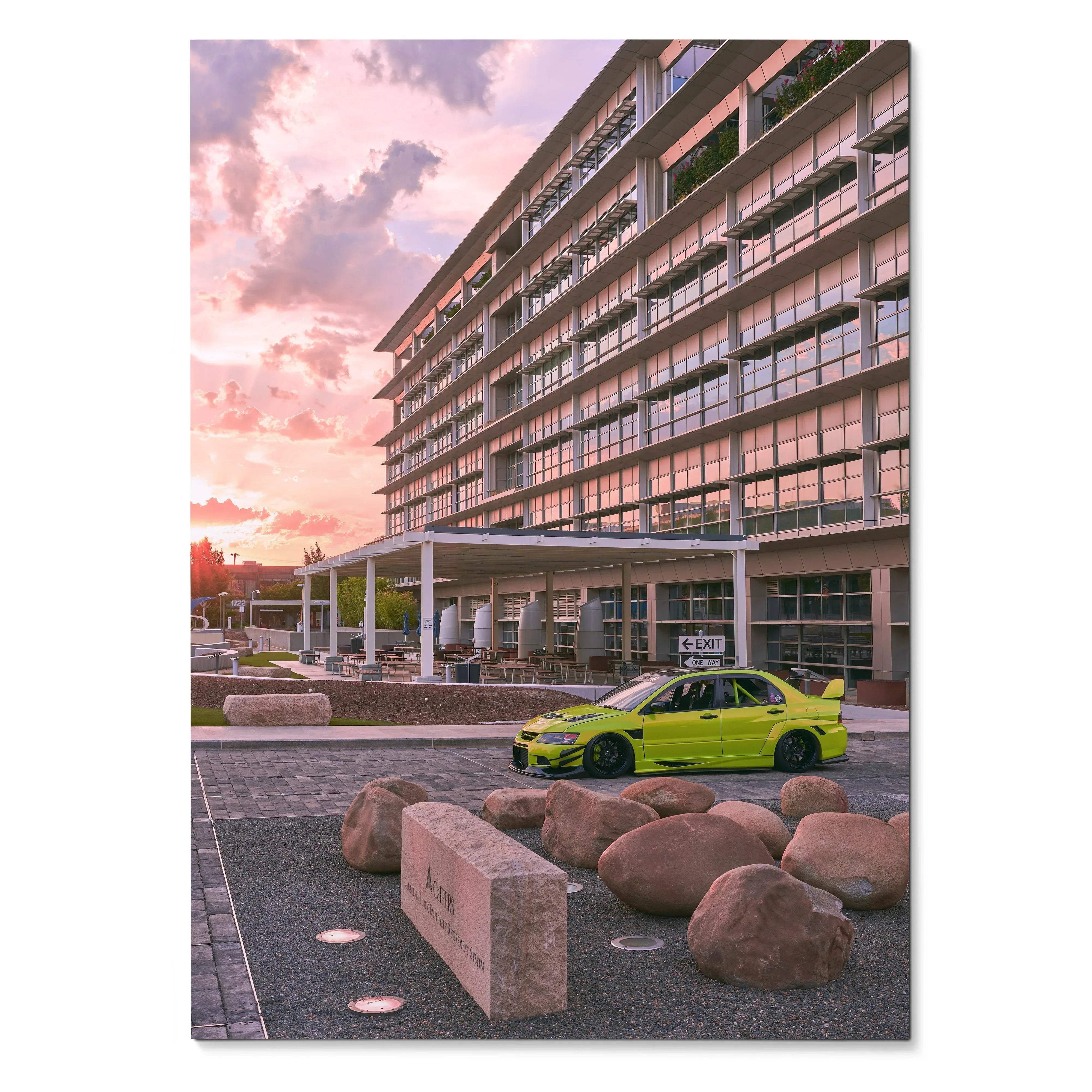 Mitsubishi Evo 9 in bright lime green parked by modern building at sunset poster wall art.