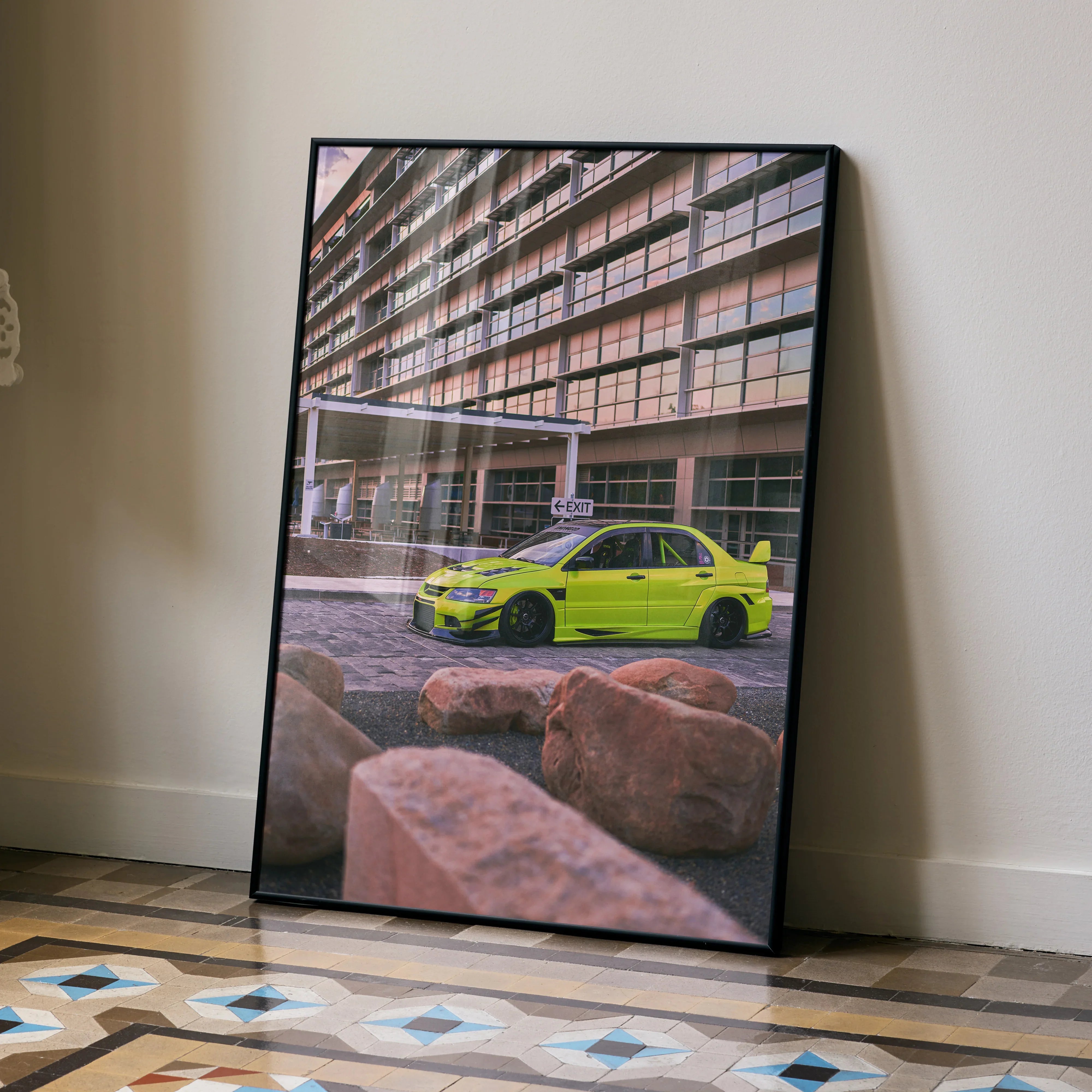Mitsubishi Evo 9 neon green car poster leaning against wall, urban architecture background wall art.
