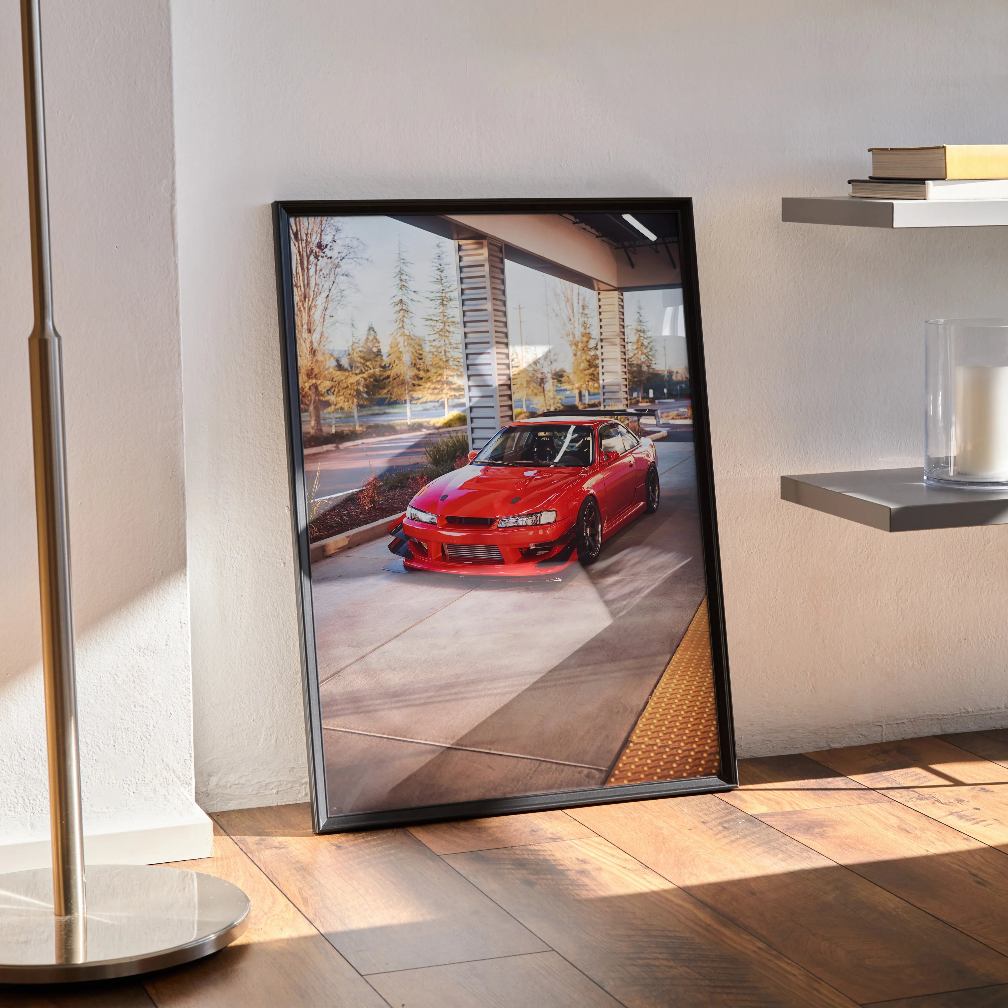 Red Nissan 240sx S14 Kouki poster in black frame leaning against wall, automotive wall art.