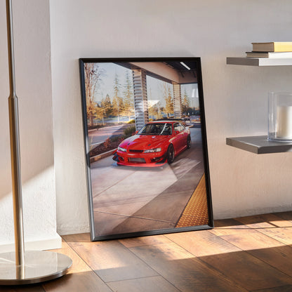 Red Nissan 240sx S14 Kouki poster in black frame leaning against wall, automotive wall art.