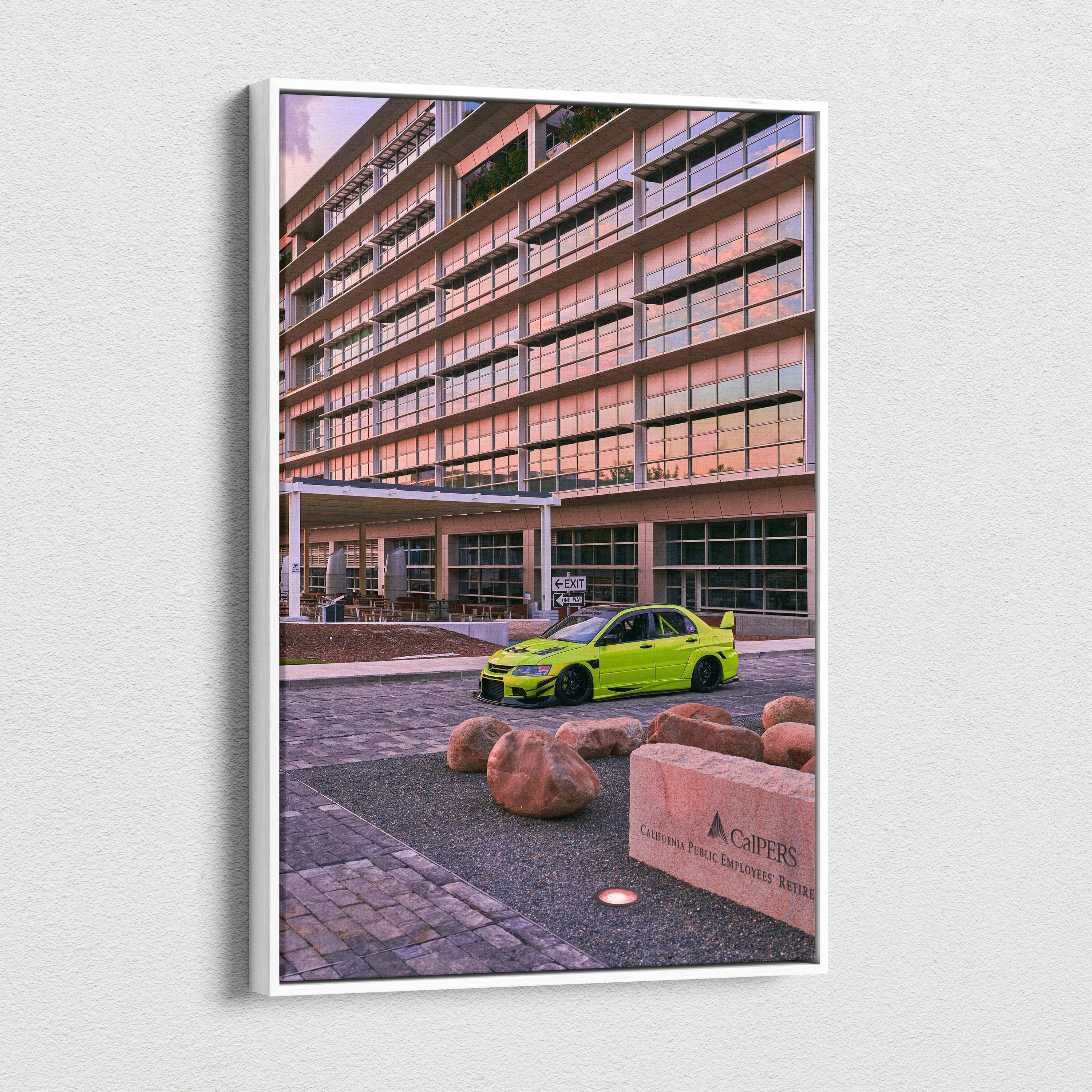 Vertical canvas wall art featuring a bright green Mitsubishi Evo 9 parked by a modern building at sunset.