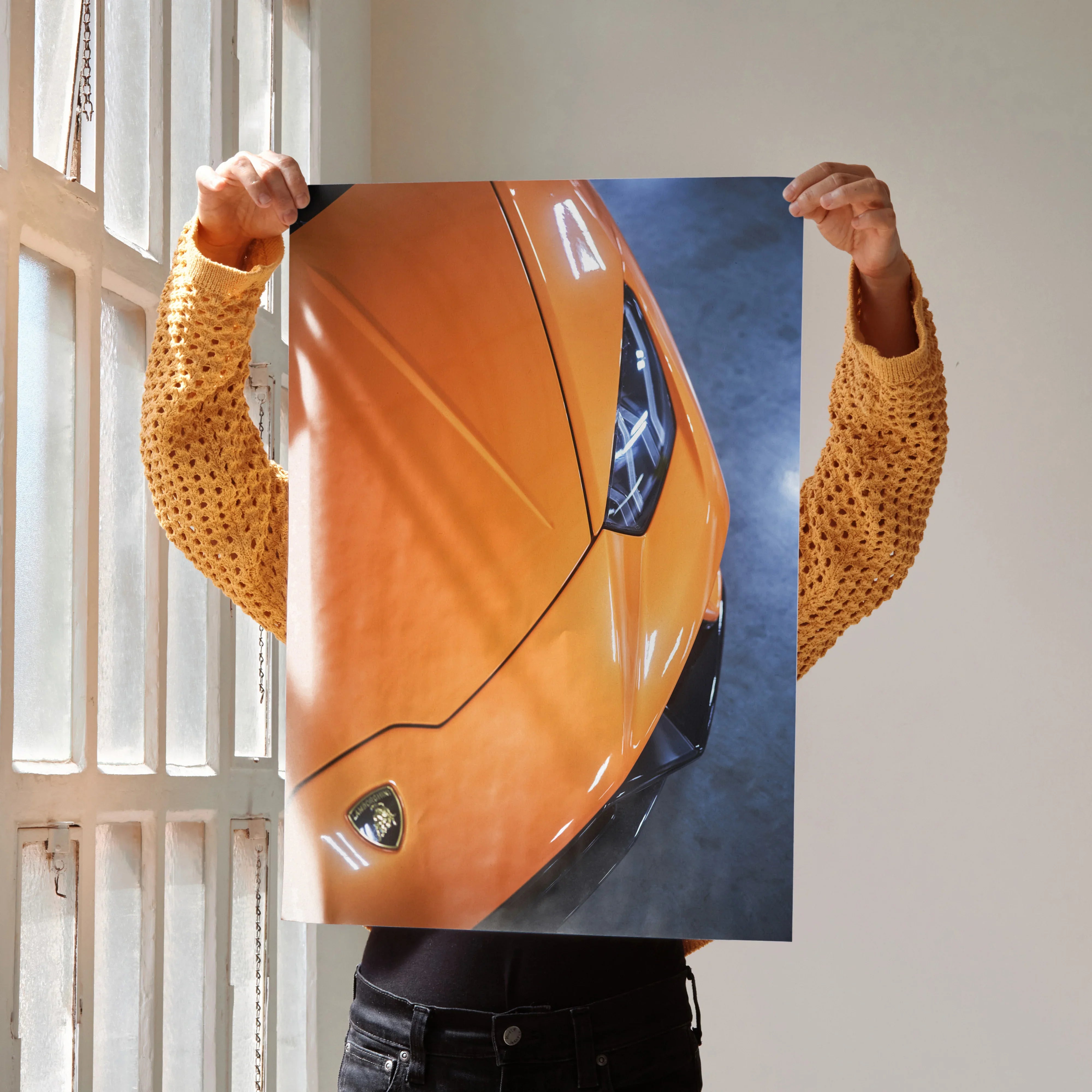 Lamborghini Huracan orange close-up poster wall art held by person in patterned yellow shirt.