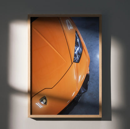 Orange Lamborghini Huracan close-up poster showcasing sleek front design, wall art in wooden frame.