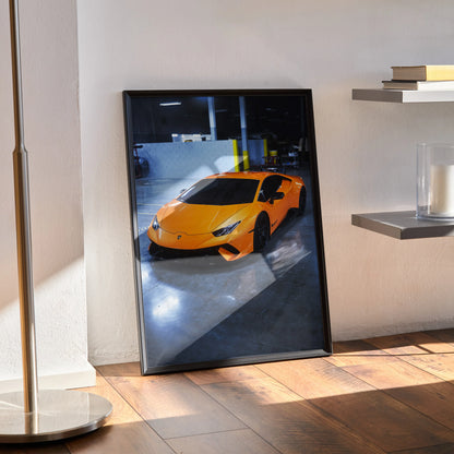 Lamborghini Huracan poster wall art with vibrant orange sports car in sleek garage setting.