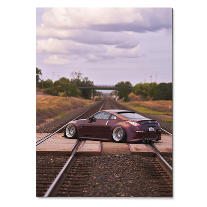 Nissan 350Z in matte purple parked on train tracks at sunset poster wall art.