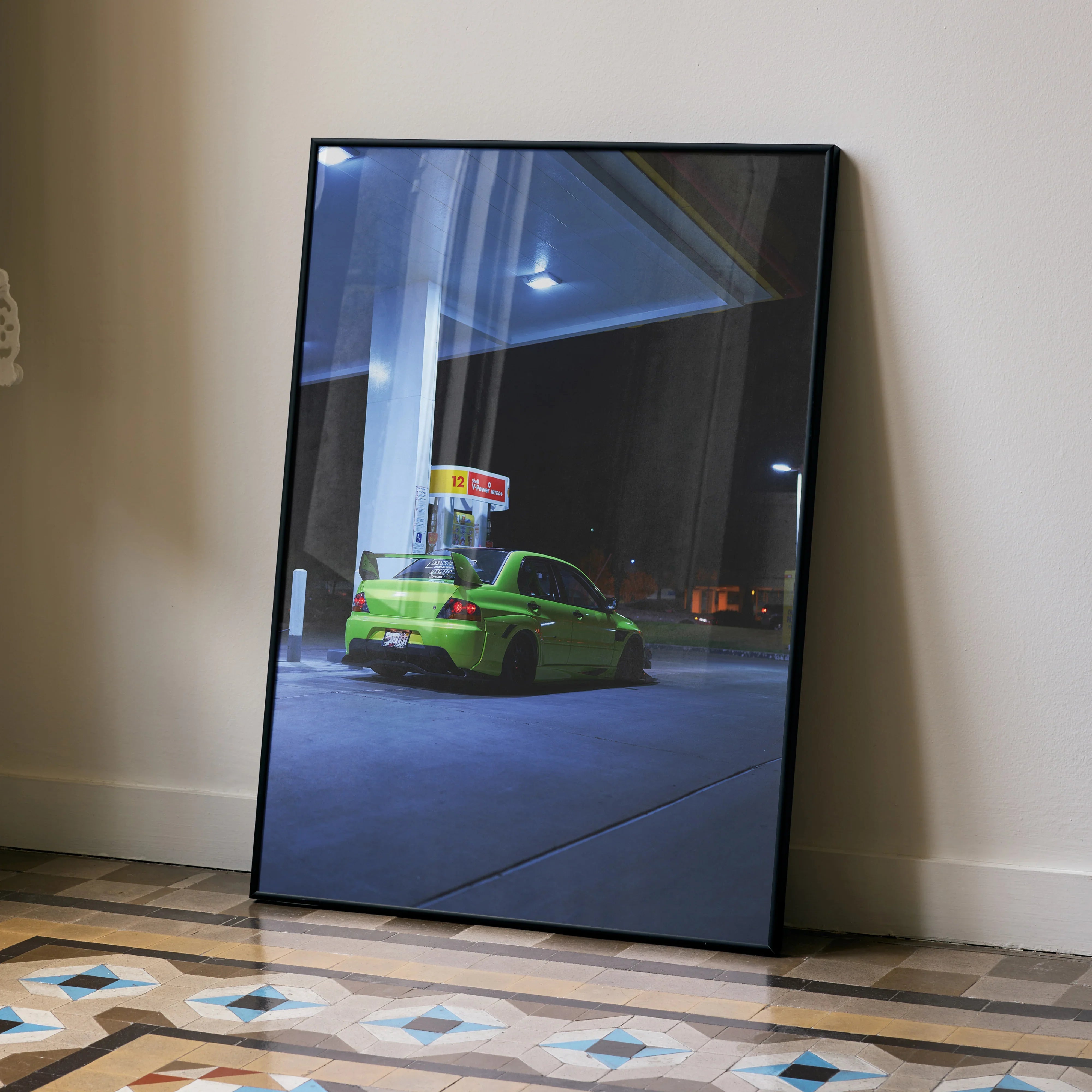 Mitsubishi Evo 9 bright green car parked at night gas station poster wall art in black frame.