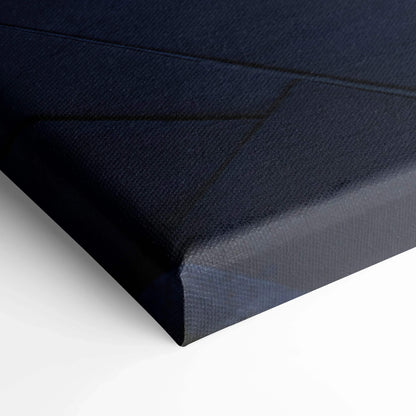 Close-up of black canvas texture on stretched vertical wall art with sharp corner edges.