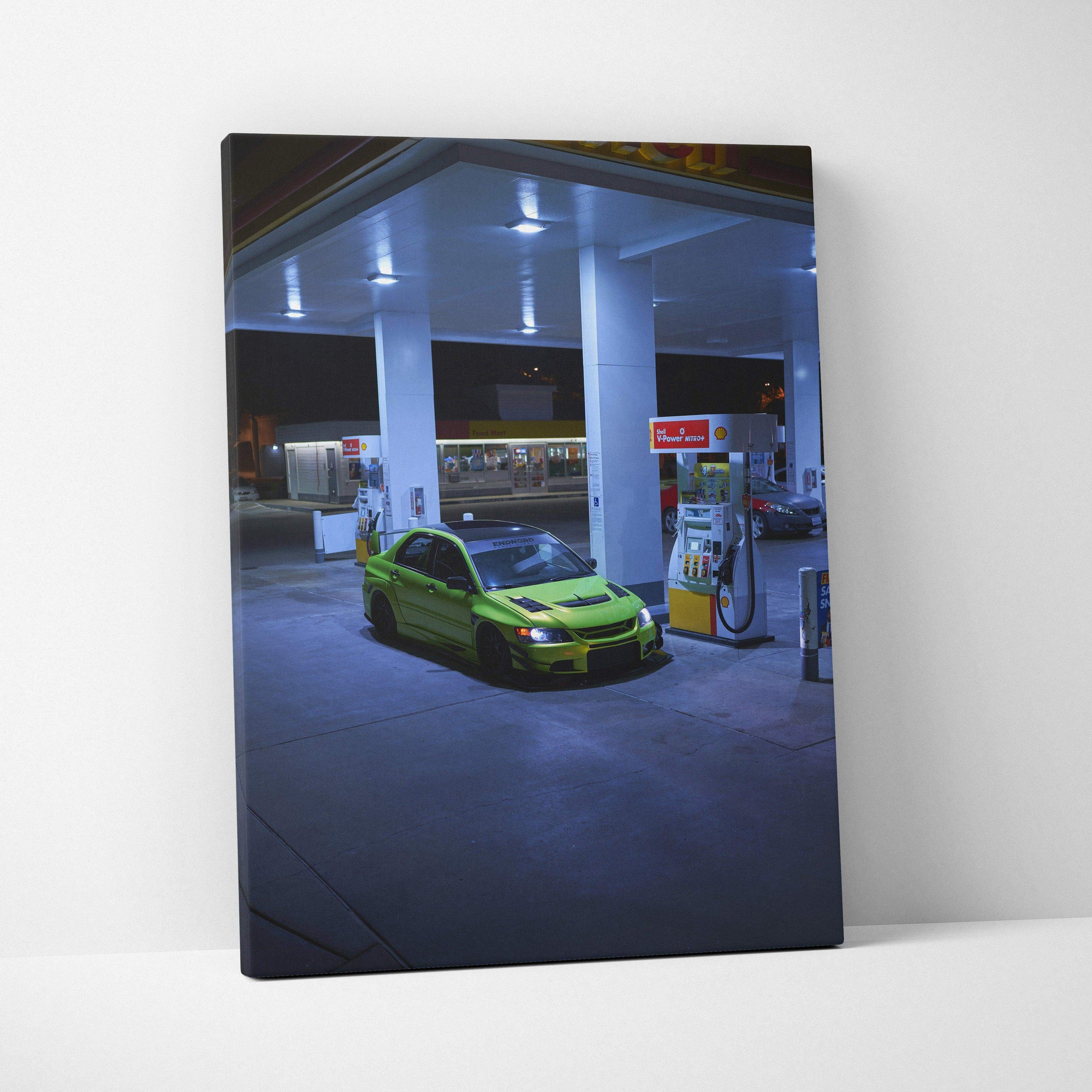 Mitsubishi Evo 9 in green parked at gas station at night vertical canvas wall art.