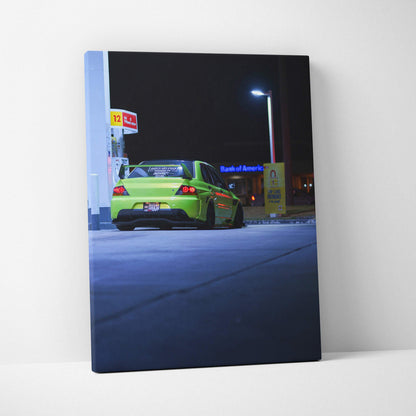 Vertical canvas art of a green Mitsubishi Evo 9 parked under bright gas station lights at night, automotive wall art.