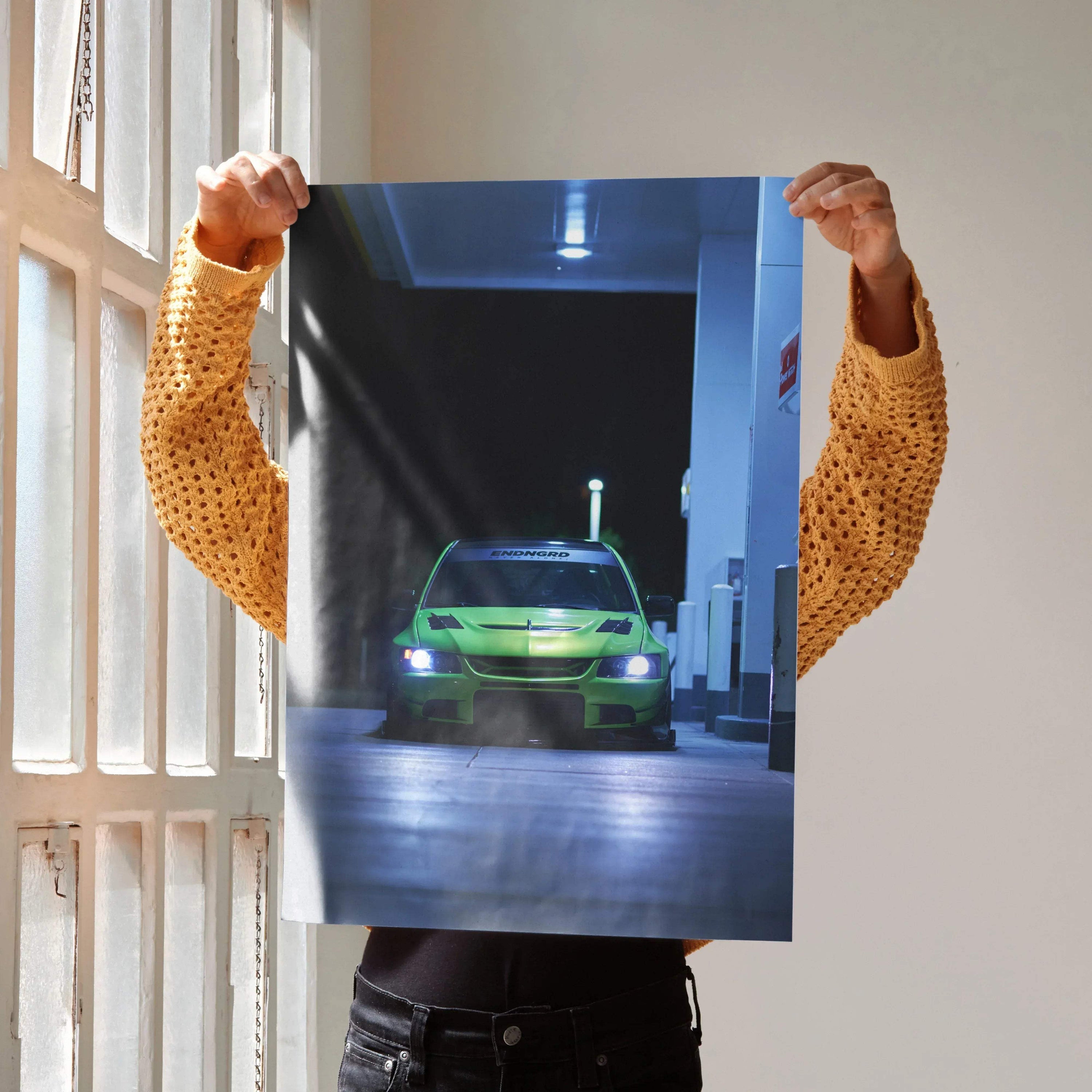 Mitsubishi Evo 9 poster with glowing headlights in a dark urban setting, wall art for car enthusiasts.