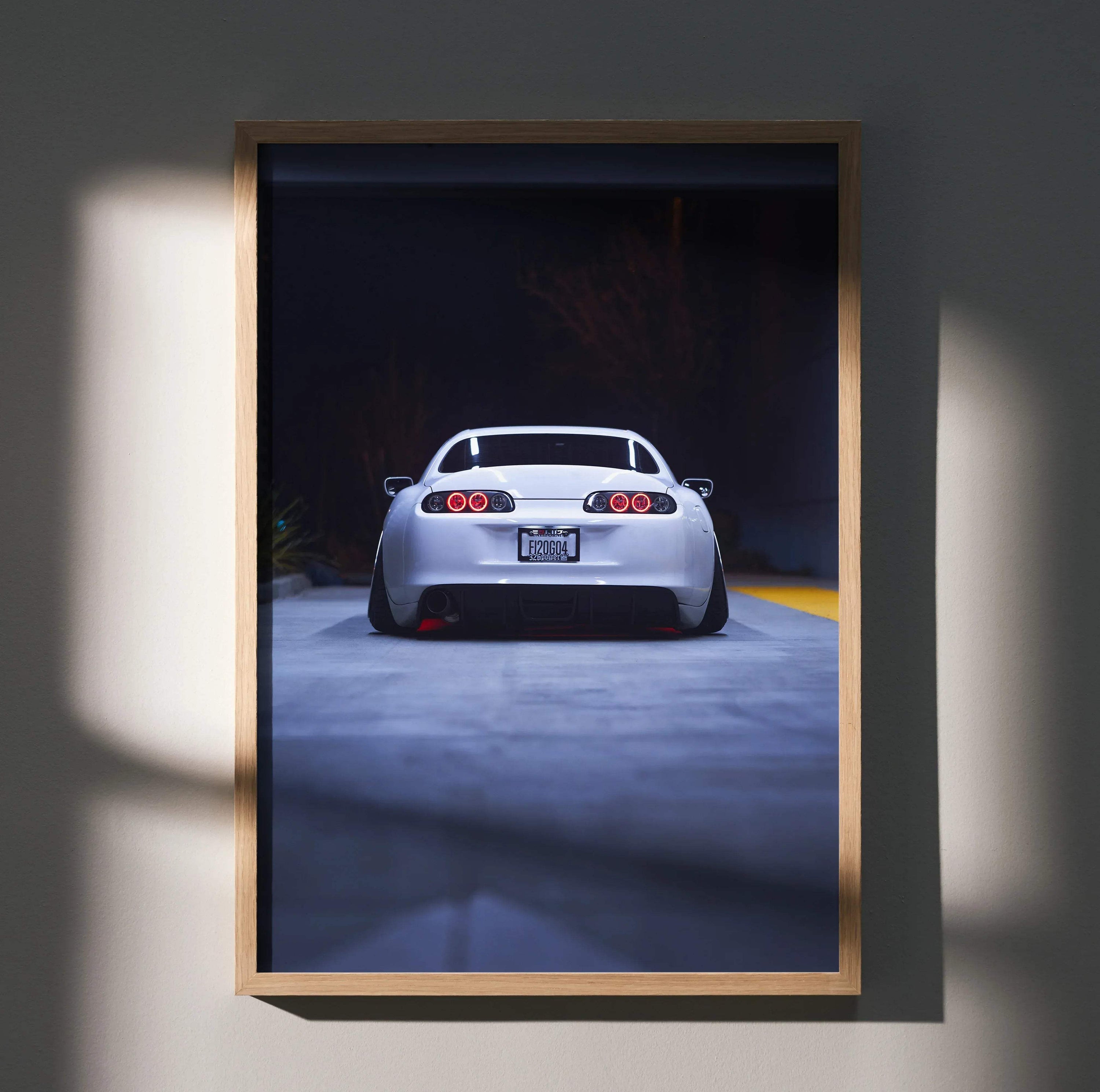 Toyota Supra MK4 JDM rear view poster wall art with dark background in wooden frame.
