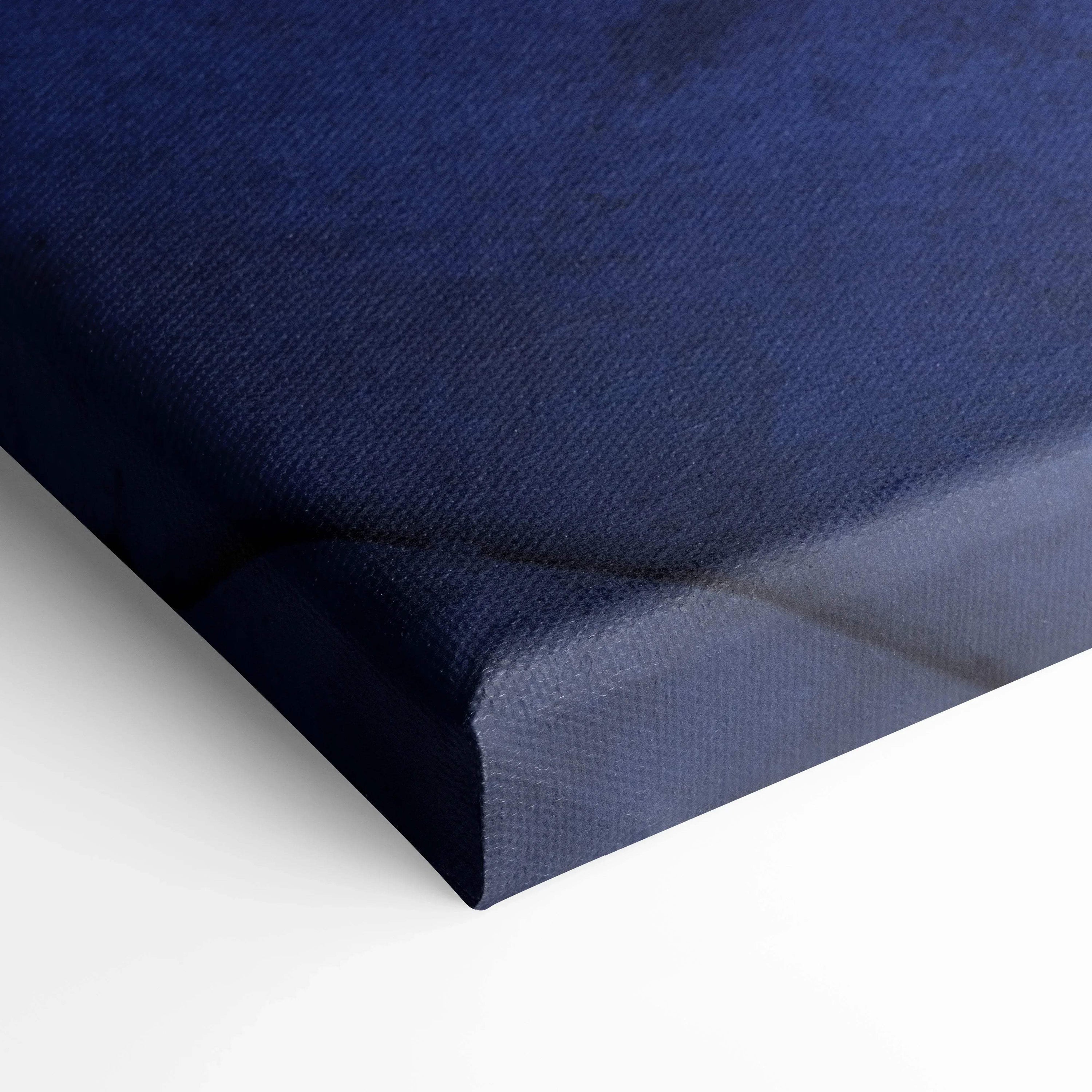 Close-up of deep blue canvas art corner with textured fabric and wrapped edges, vertical wall art.