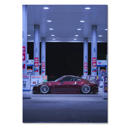 Red Nissan 350Z parked at gas station at night poster wall art.