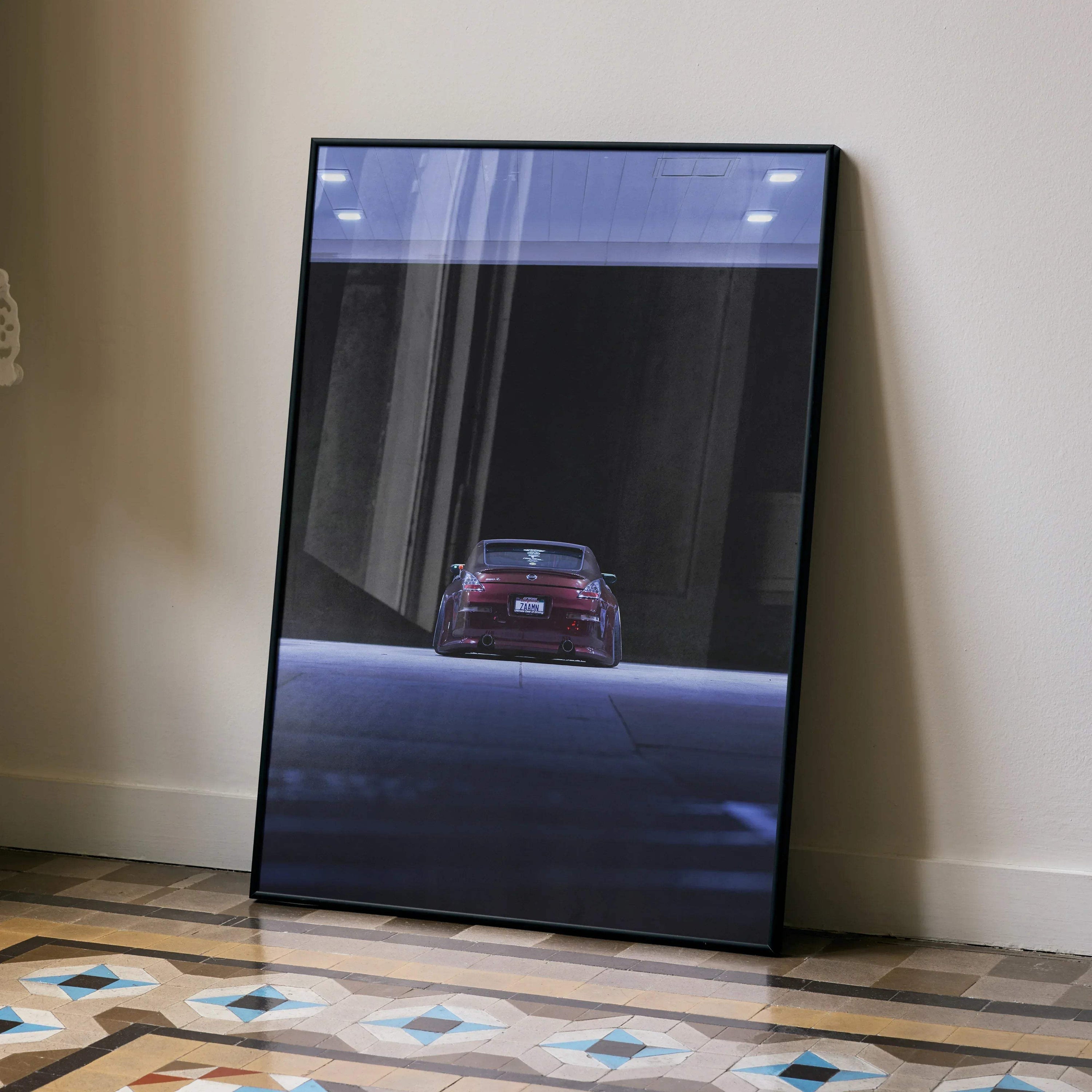 Nissan 350Z rear view automotive art poster in black frame leaning on wall, modern wall art.