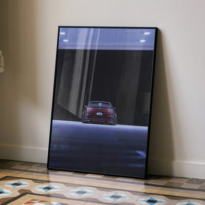 Nissan 350Z rear view automotive art poster in black frame leaning on wall, modern wall art.
