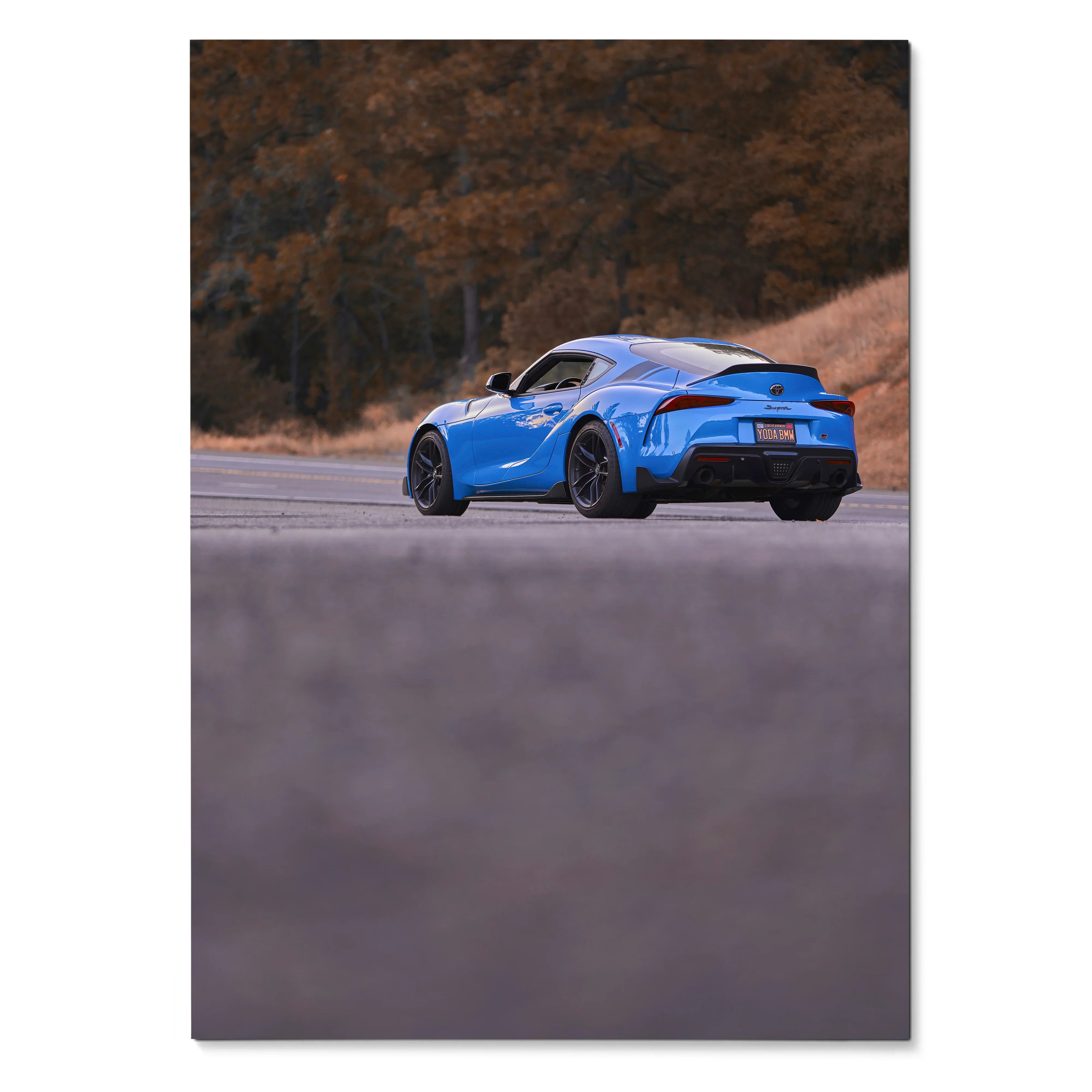 Blue Toyota Supra MK5 sports car on road with autumn trees backdrop poster wall art.