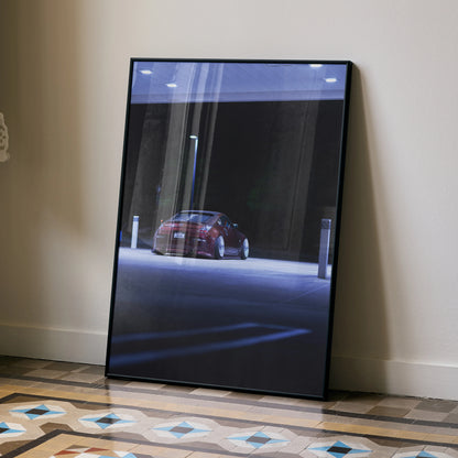 Nissan 350Z poster with sleek red car under dim street lighting, modern wall art in black frame.