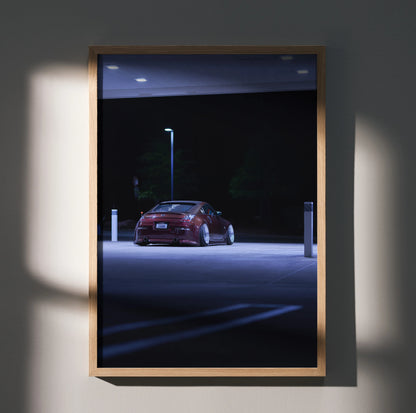 Nissan 350Z red sports car under streetlight at night poster wall art in wooden frame.