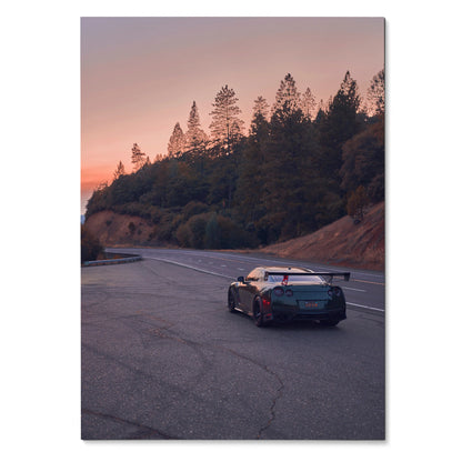 Nissan GTR R35 poster with black sports car on winding road at sunset, automotive wall art.