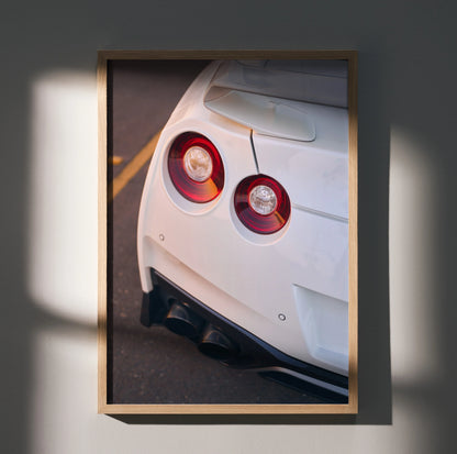Nissan GTR R35 white rear view poster with iconic round tail lights, automotive wall art.