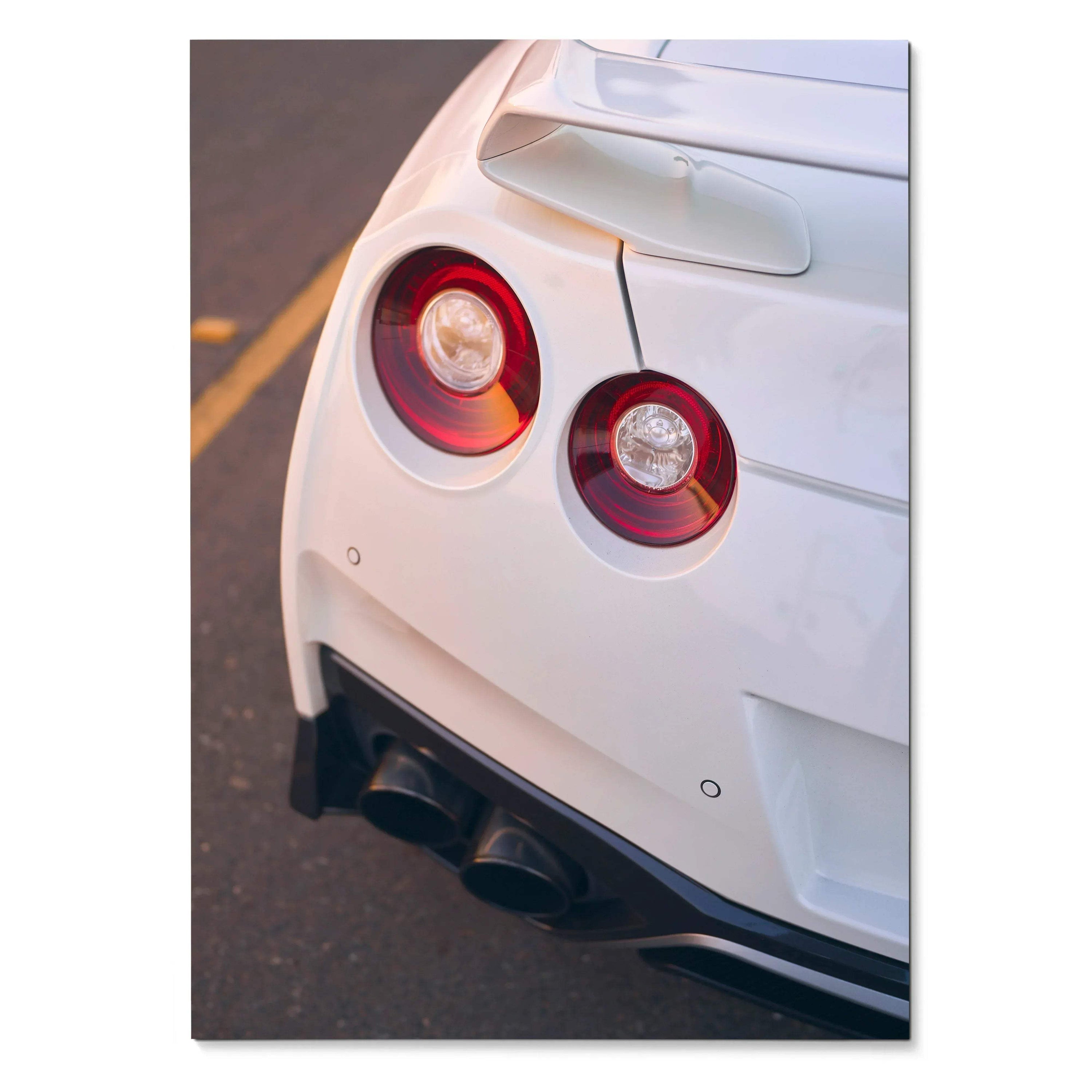 White Nissan GTR R35 rear with round taillights and black exhaust pipes poster wall art.