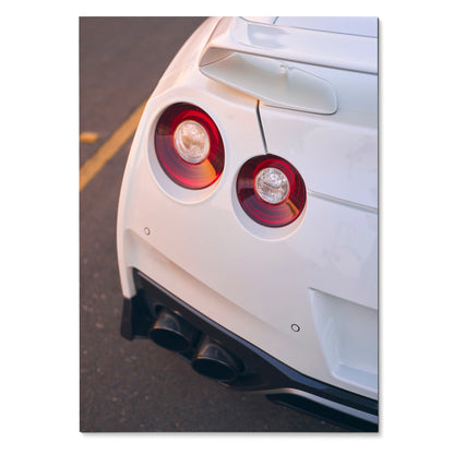 White Nissan GTR R35 rear with round taillights and black exhaust pipes poster wall art.