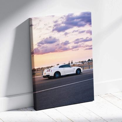 White Nissan R35 GTR on road at sunset on vertical canvas wall art.