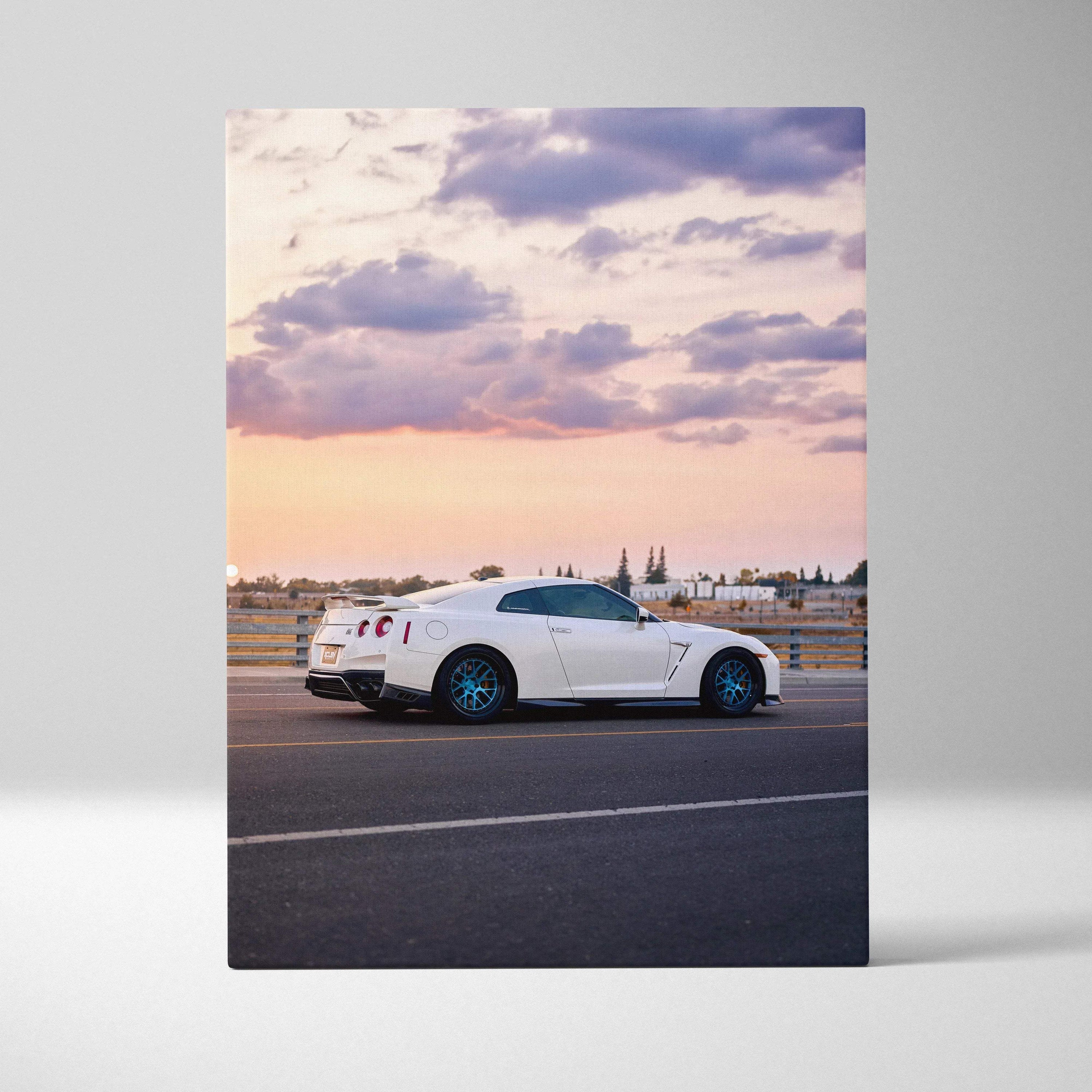 White Nissan R35 GTR on road at sunset with dramatic clouds canvas wall art.