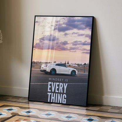 Motivational poster with white Nissan R35 GT-R under a cloudy sunset sky, inspirational wall art.
