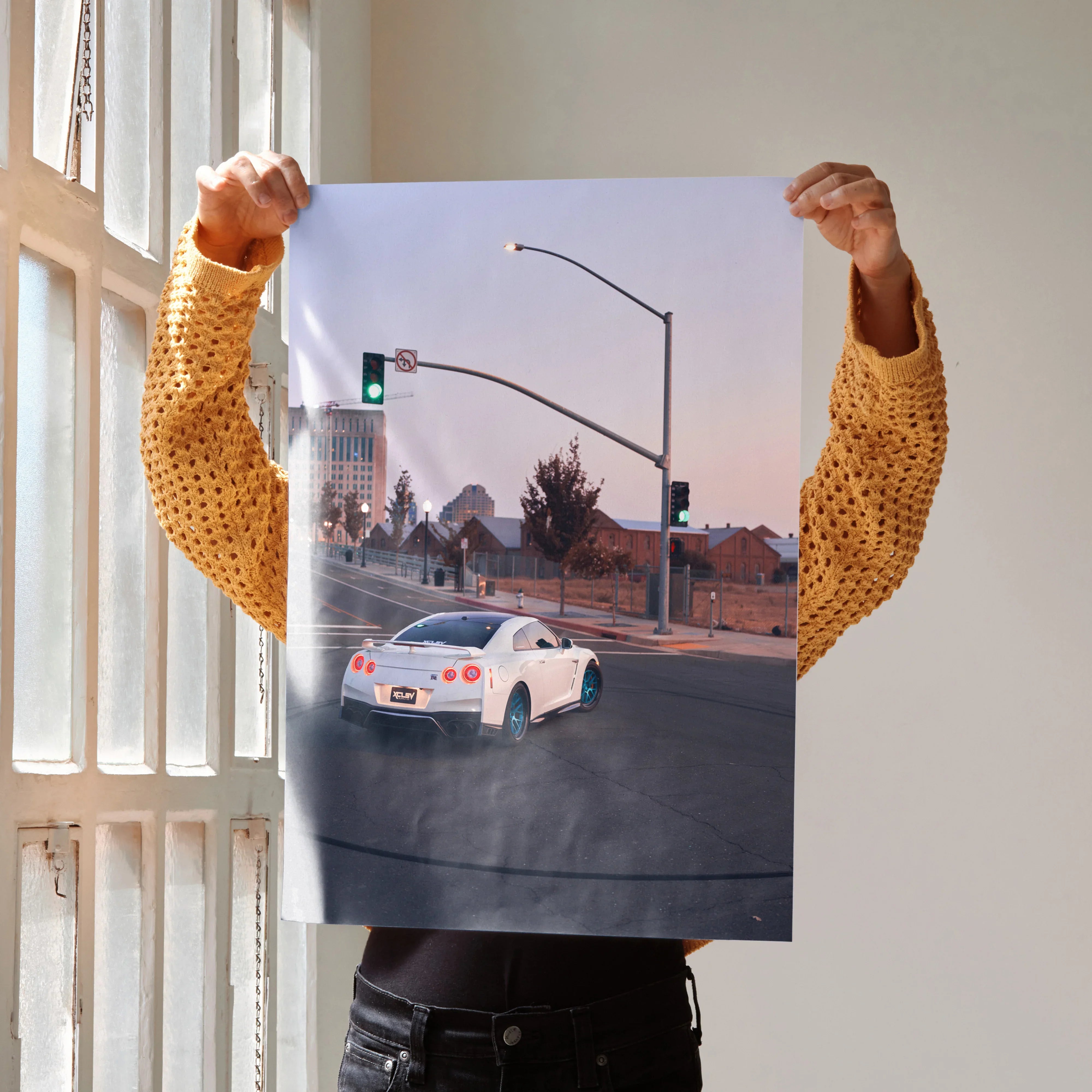 White Nissan GTR R35 driving at an urban intersection poster wall art.