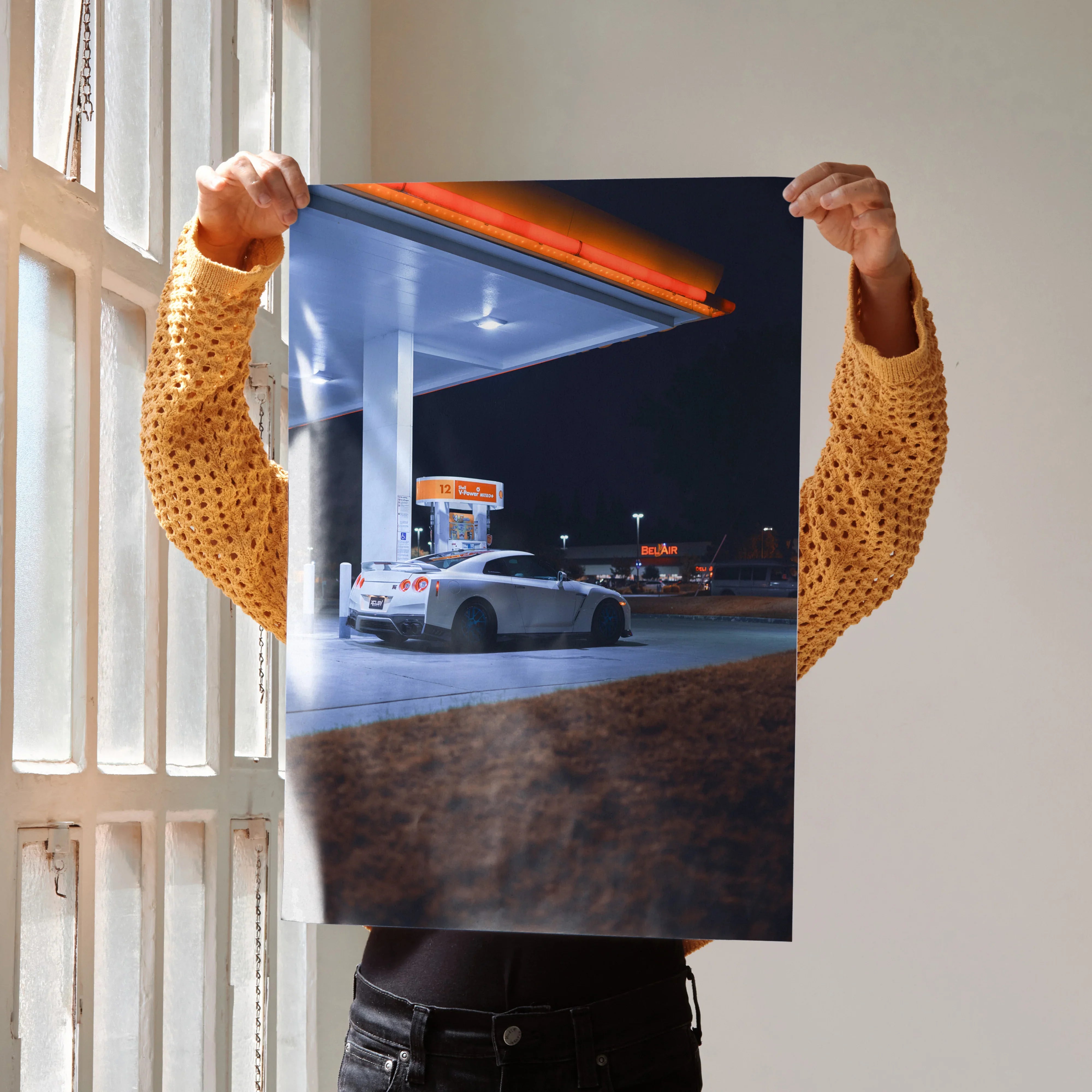 Nissan GTR R35 parked at gas station at night poster wall art with vibrant lighting.