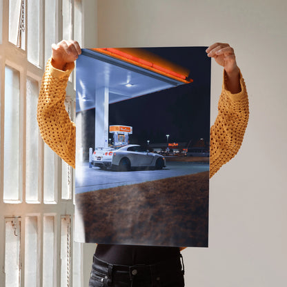 Nissan GTR R35 parked at gas station at night poster wall art with vibrant lighting.