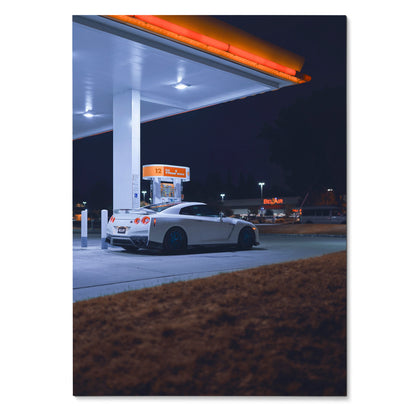 Nissan GTR R35 poster showing white sports car at gas station at night, automotive wall art.