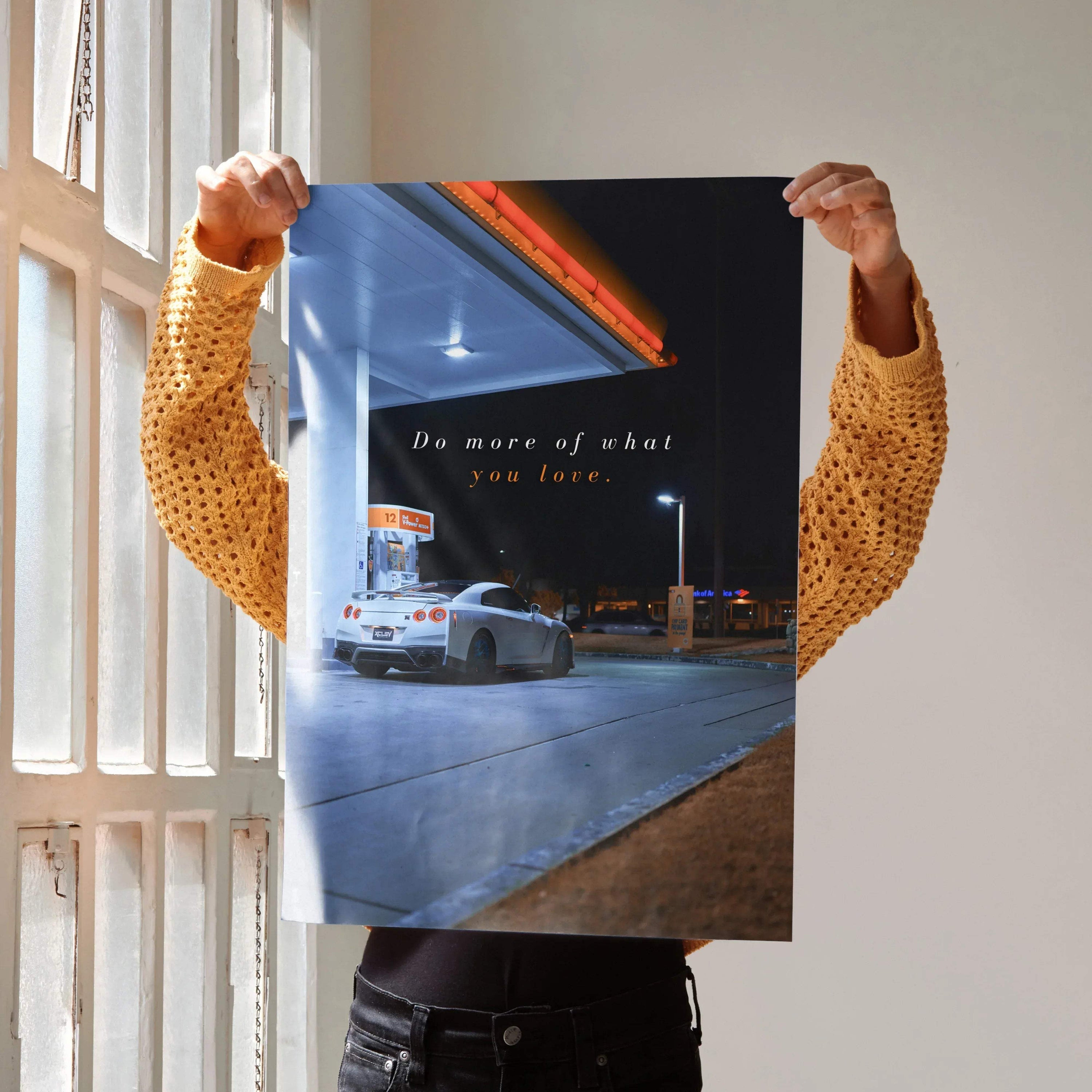 Poster wall art featuring a white Nissan R35 GT-R at a gas station with motivational text.