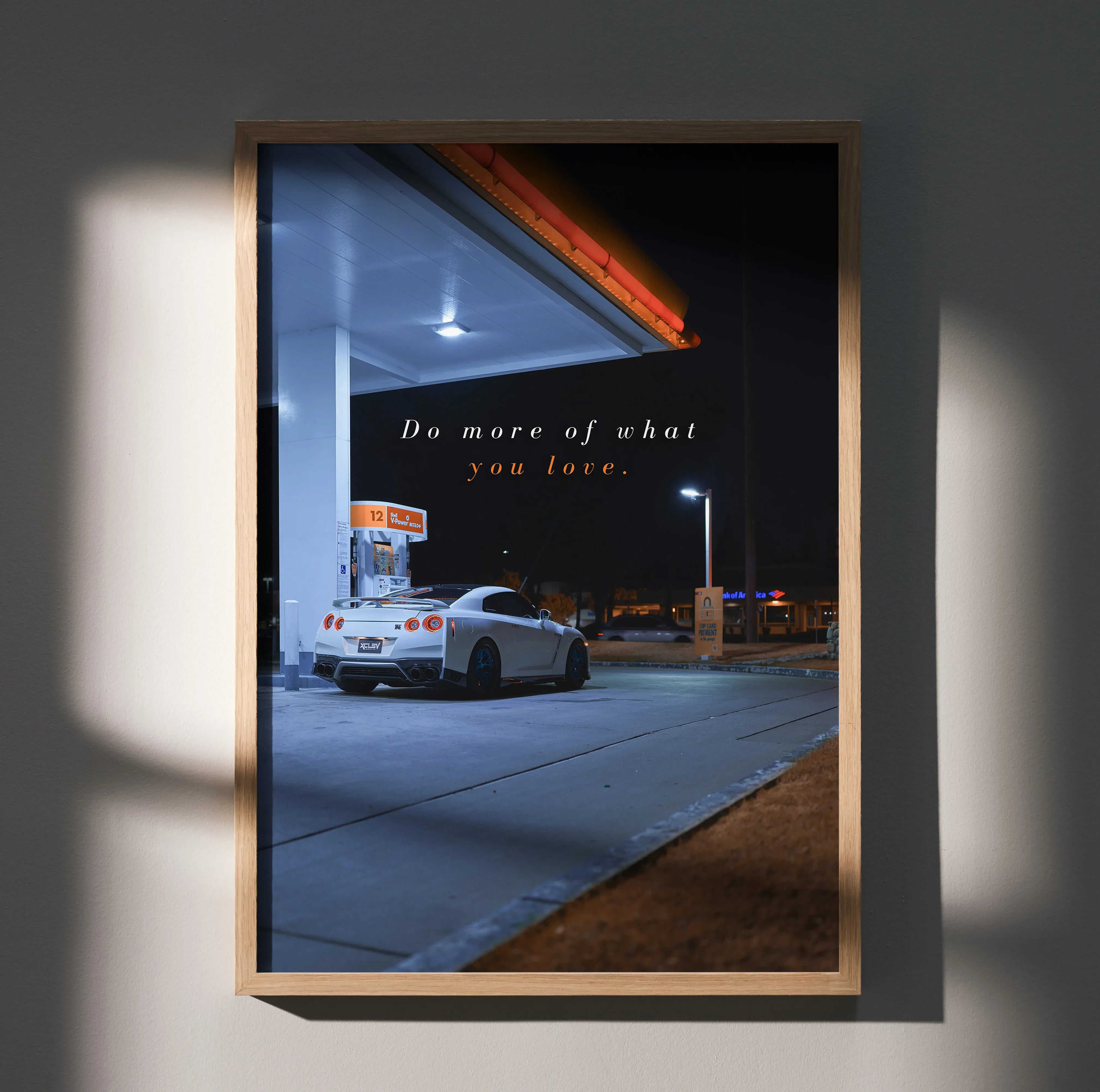 Nissan R35 GT-R parked under gas station light at night with motivational text poster wall art.