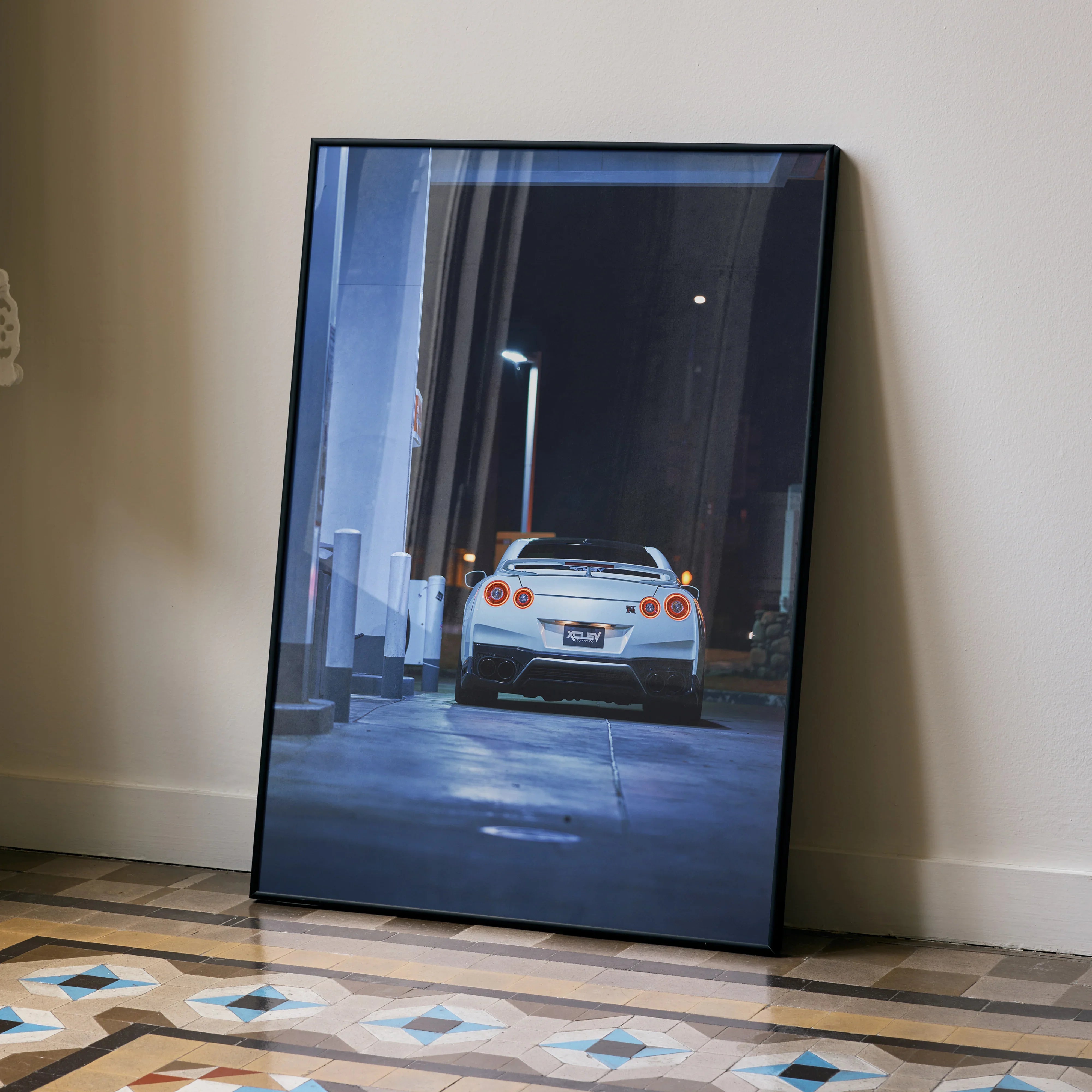 Nissan GTR R35 automotive art poster showing rear view in nighttime alleyway, wall art with dark tones and modern urban.