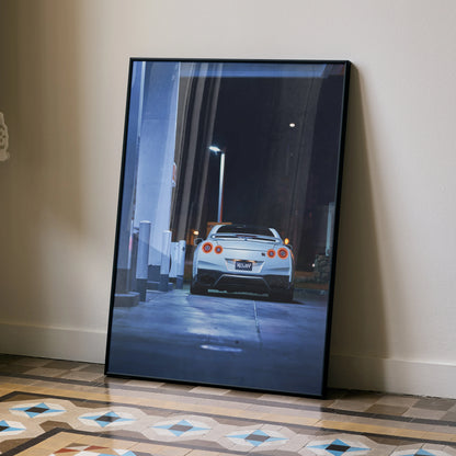 Nissan GTR R35 automotive art poster showing rear view in nighttime alleyway, wall art with dark tones and modern urban.