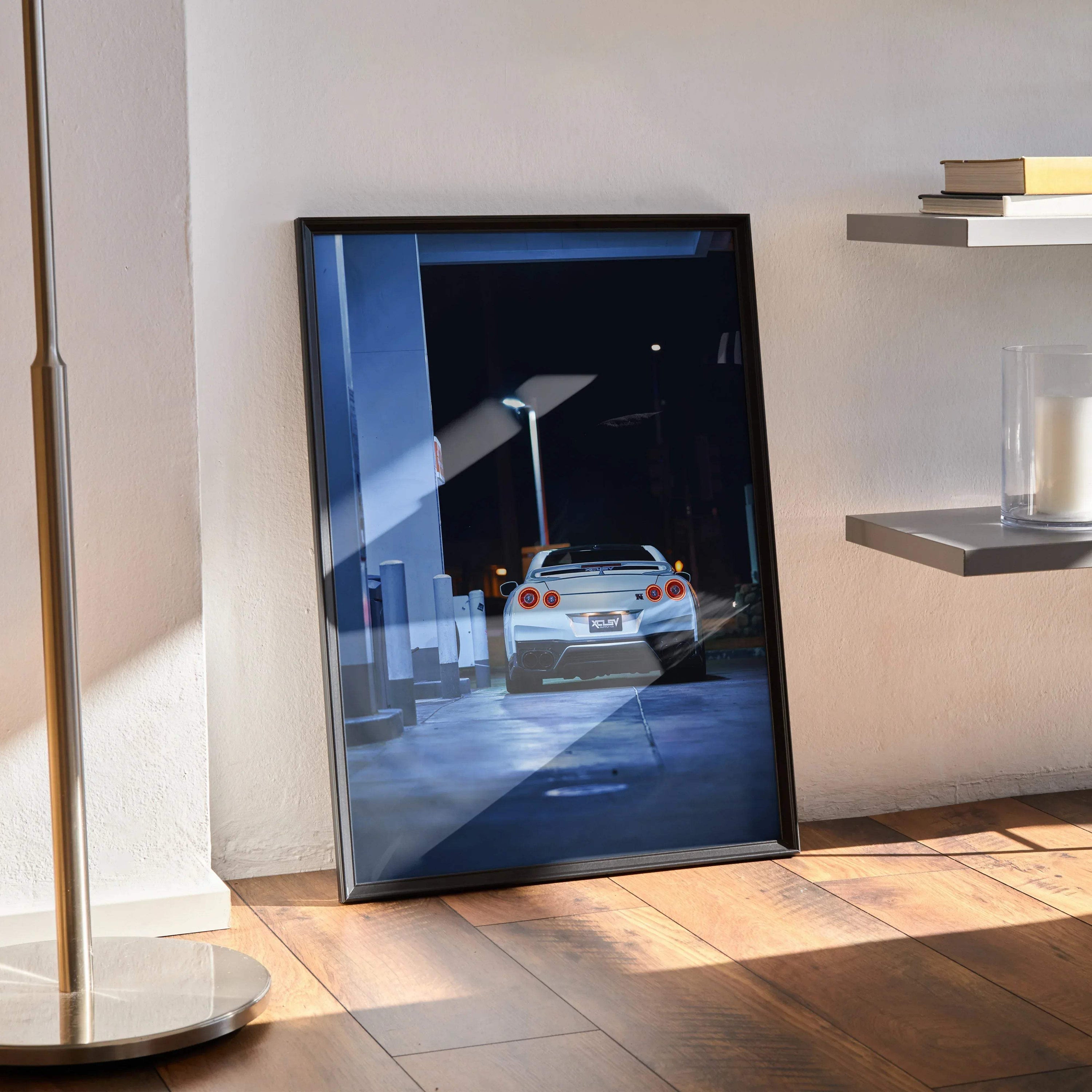 Nissan GTR R35 poster wall art featuring rear view of white sports car in dark urban setting with streetlights.