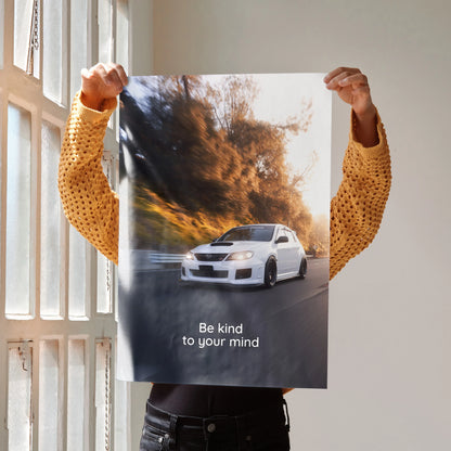 Motivational poster wall art featuring white Subaru WRX STI on winding road with inspiring text Be kind to your mind.