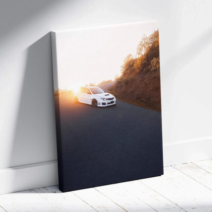 Vertical canvas wall art featuring a white Subaru WRX STI driving at sunset along a winding road.