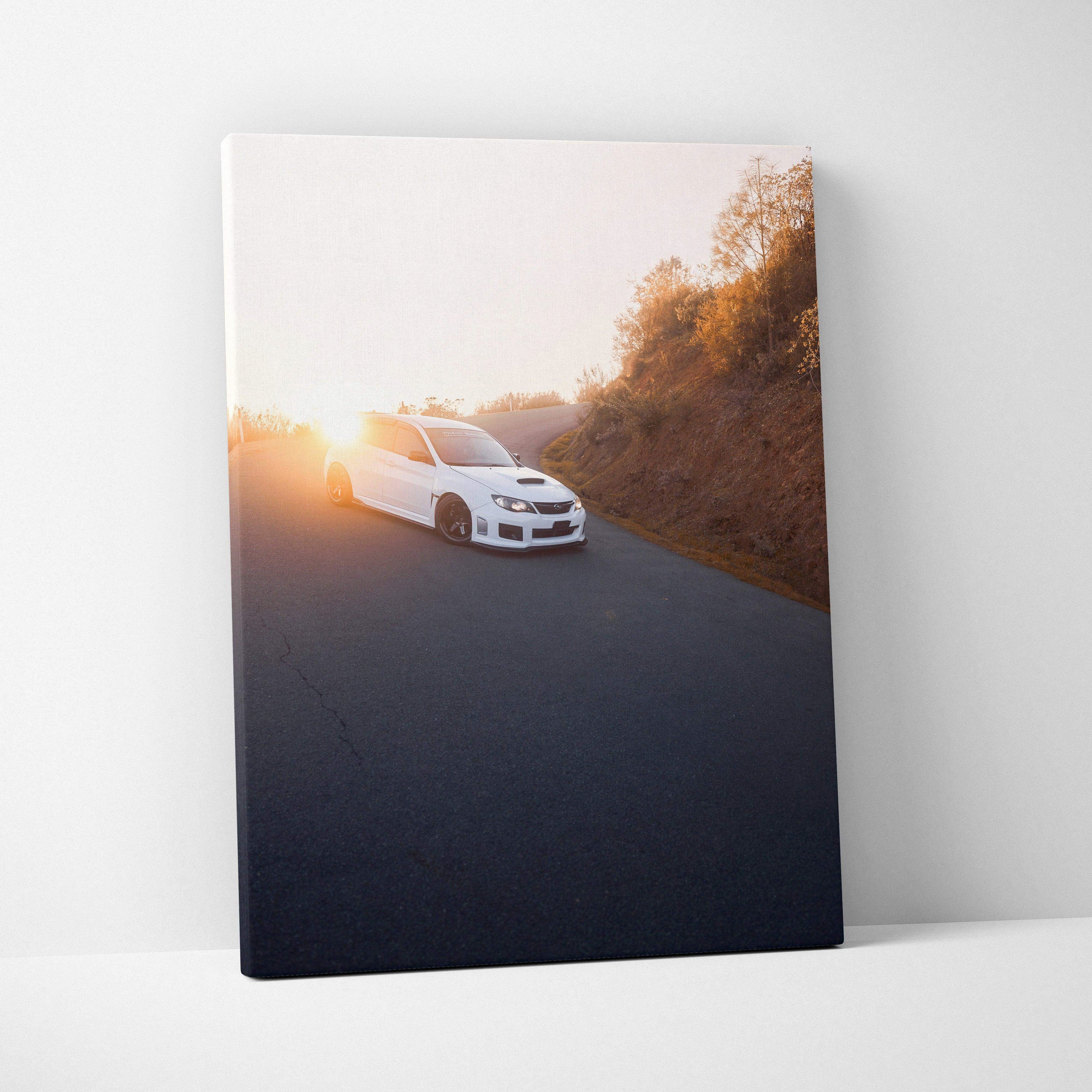Subaru WRX STI driving on road at sunset canvas wall art print with warm tones.