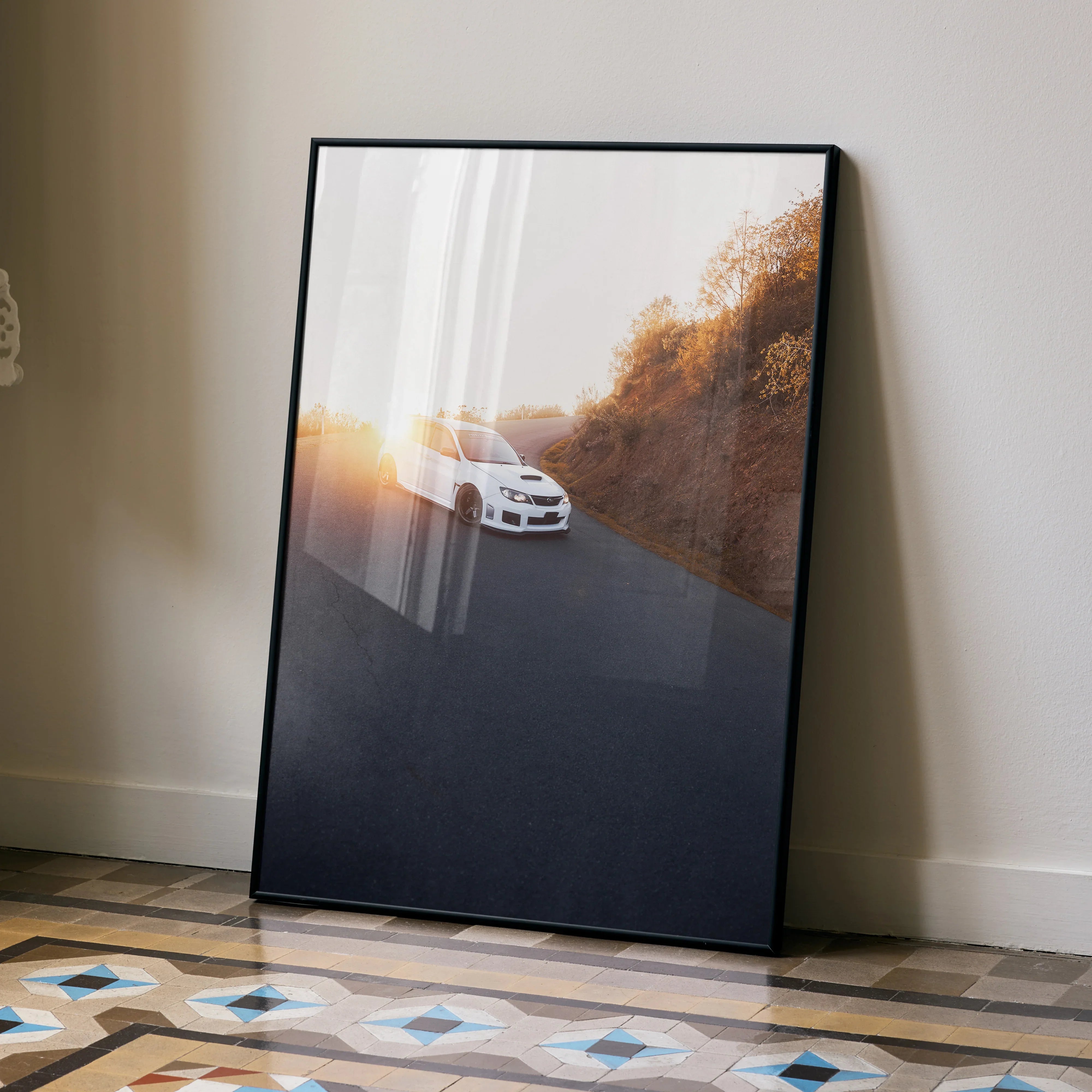 Subaru WRX STI driving at sunset with warm orange foliage, automotive wall art poster.