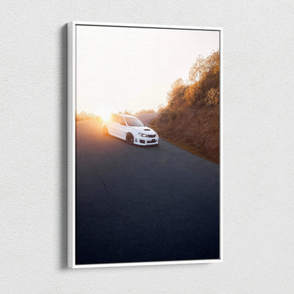 Subaru WRX STI driving at sunset on road canvas wall art with warm sky tones.
