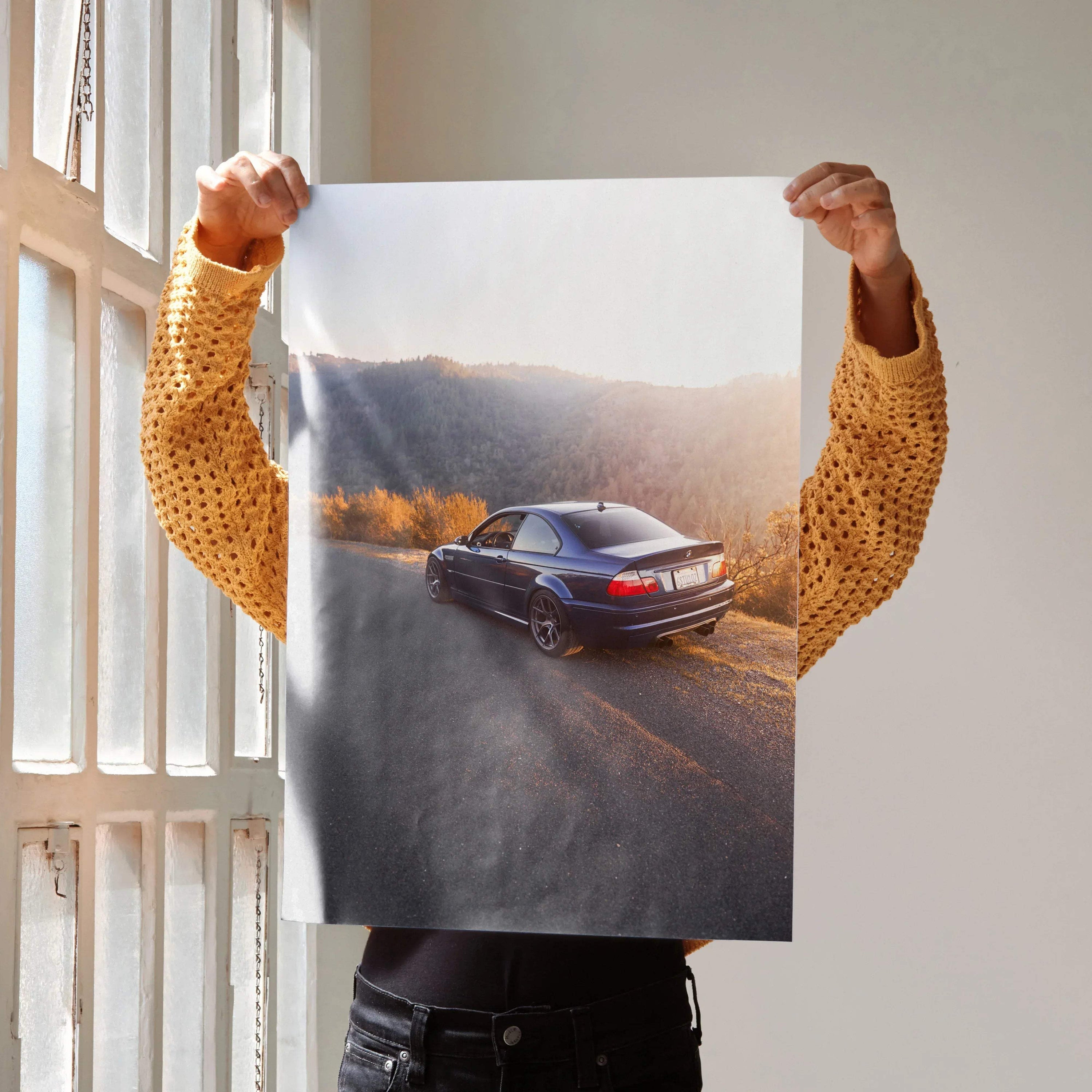 BMW E46 M3 poster showing a black car on a scenic road with autumn foliage, wall art for car enthusiasts.
