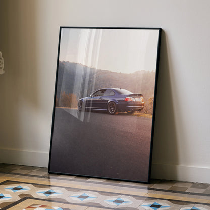 BMW E46 M3 parked on road at sunset high resolution poster wall art in black frame.