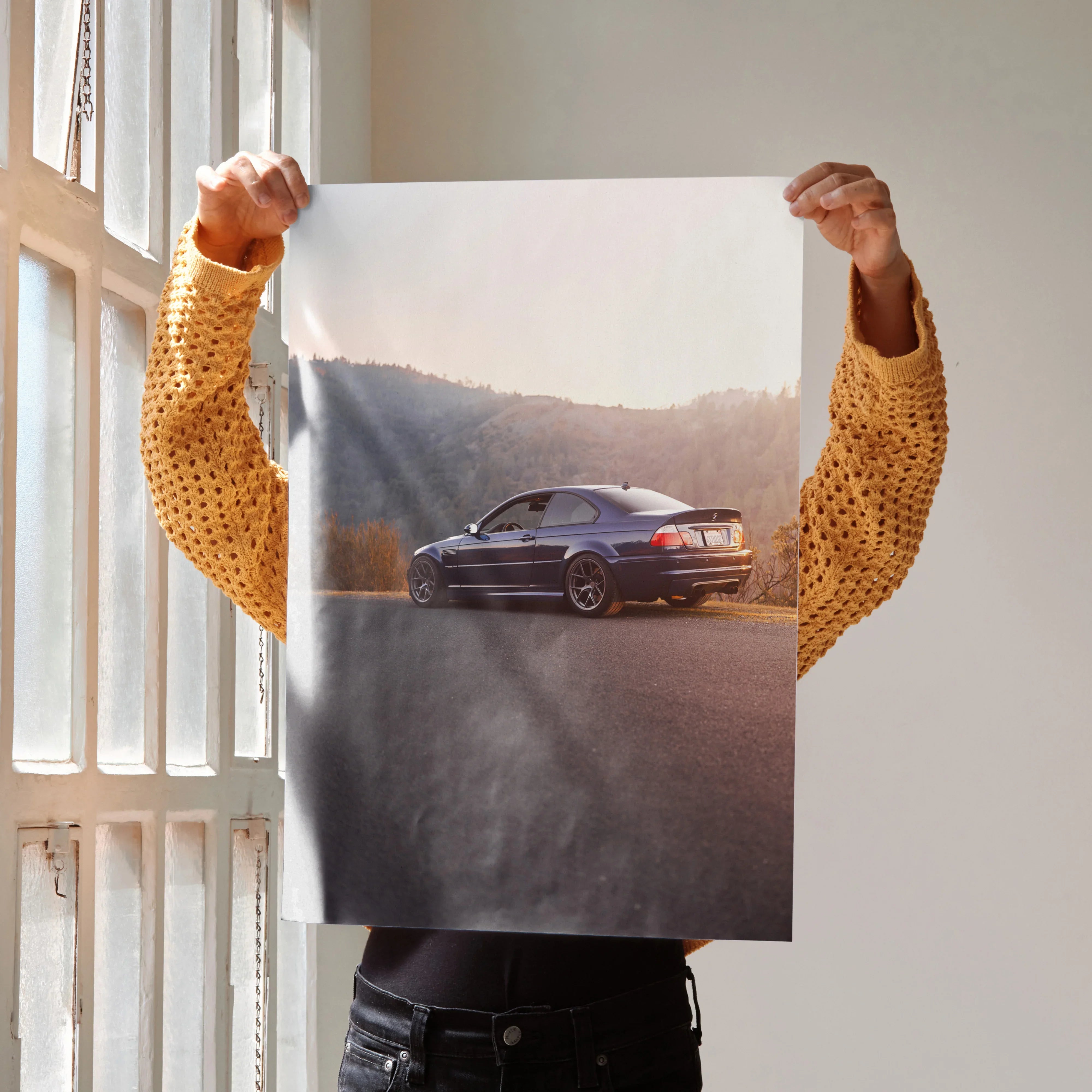 BMW E46 M3 parked on road at sunset poster wall art with scenic mountain background.