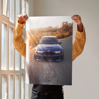 BMW E46 M3 front view poster showcasing iconic car on scenic road, automotive wall art.