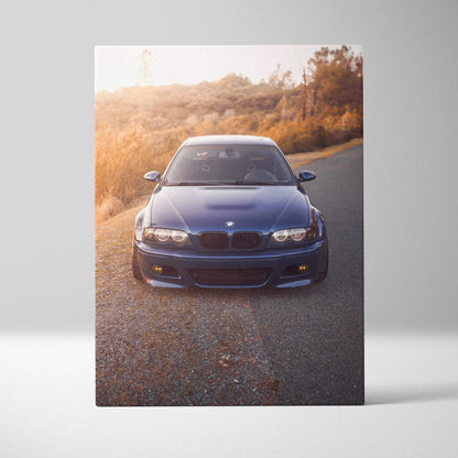 Blue BMW E46 M3 on road with warm sunset background on vertical canvas wall art.