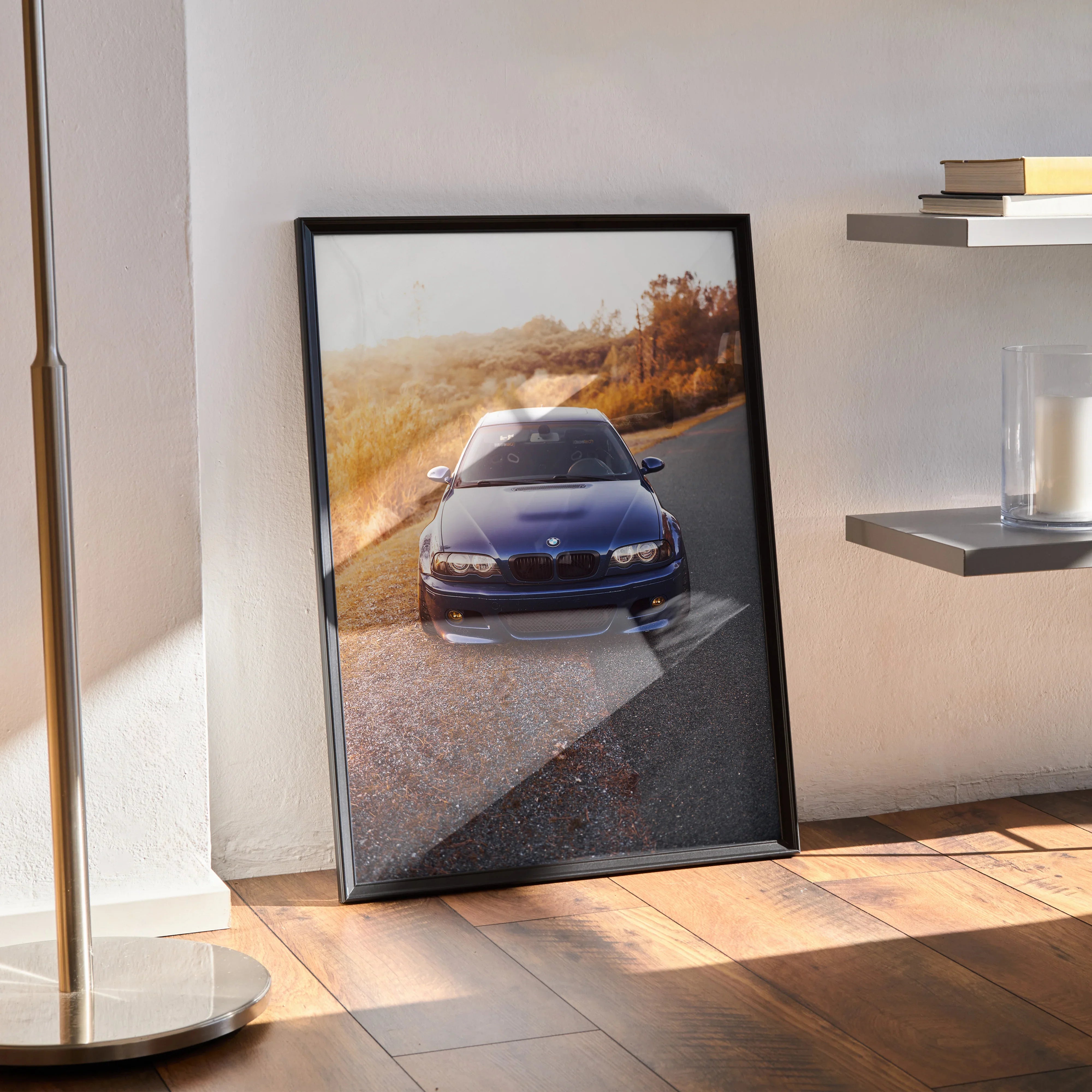 BMW E46 M3 poster leaning against wall, high-resolution automotive wall art with black frame.