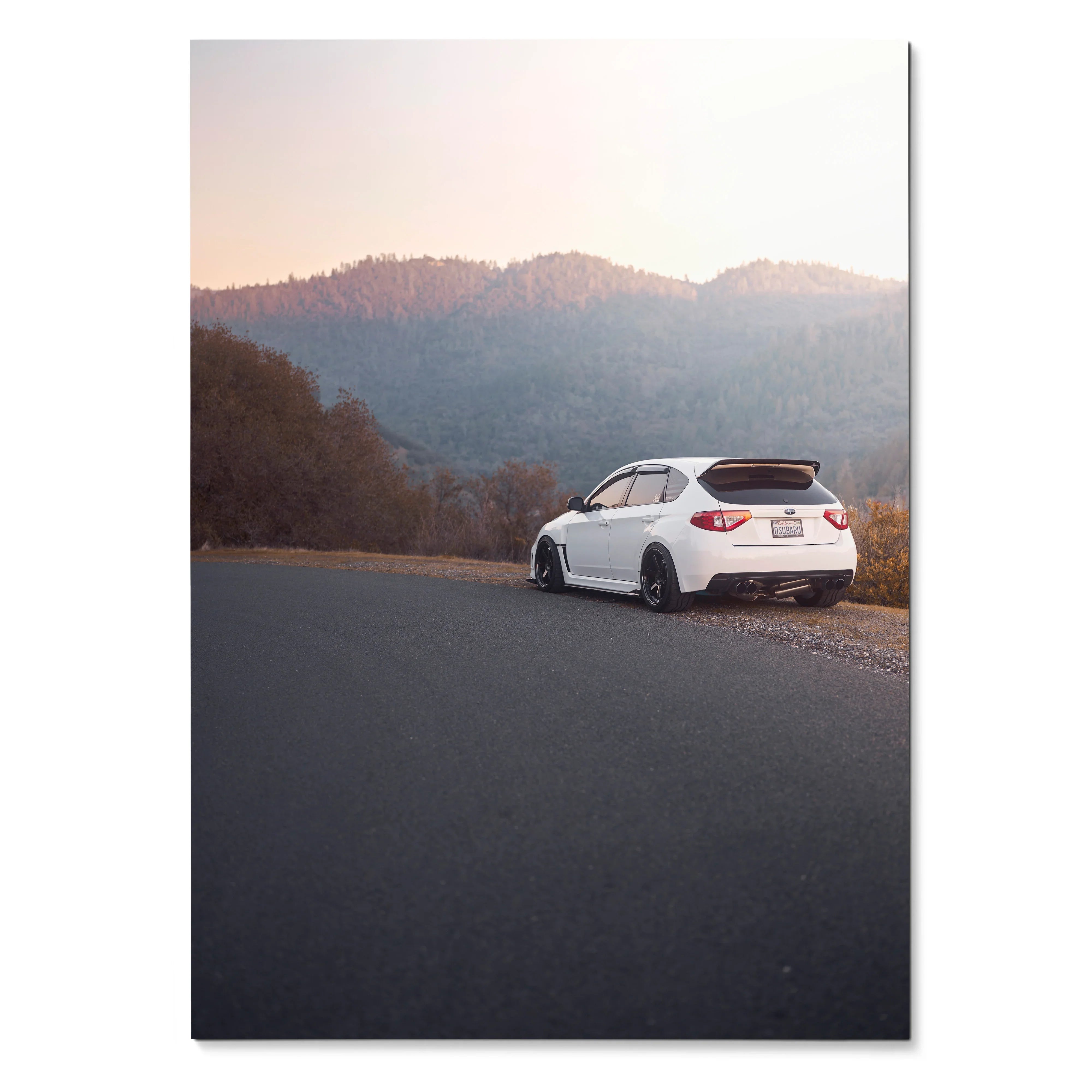 White Subaru WRX STI parked on roadside with mountain landscape at sunset poster wall art.